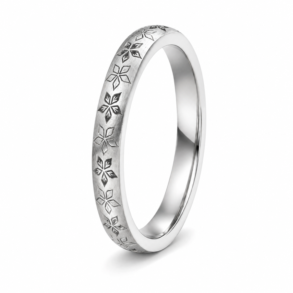 A platinum wedding ring featuring a repeating engraved floral or snowflake-like pattern.