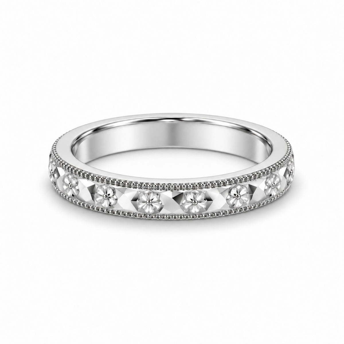 A platinum wedding ring with a floral engraved pattern.