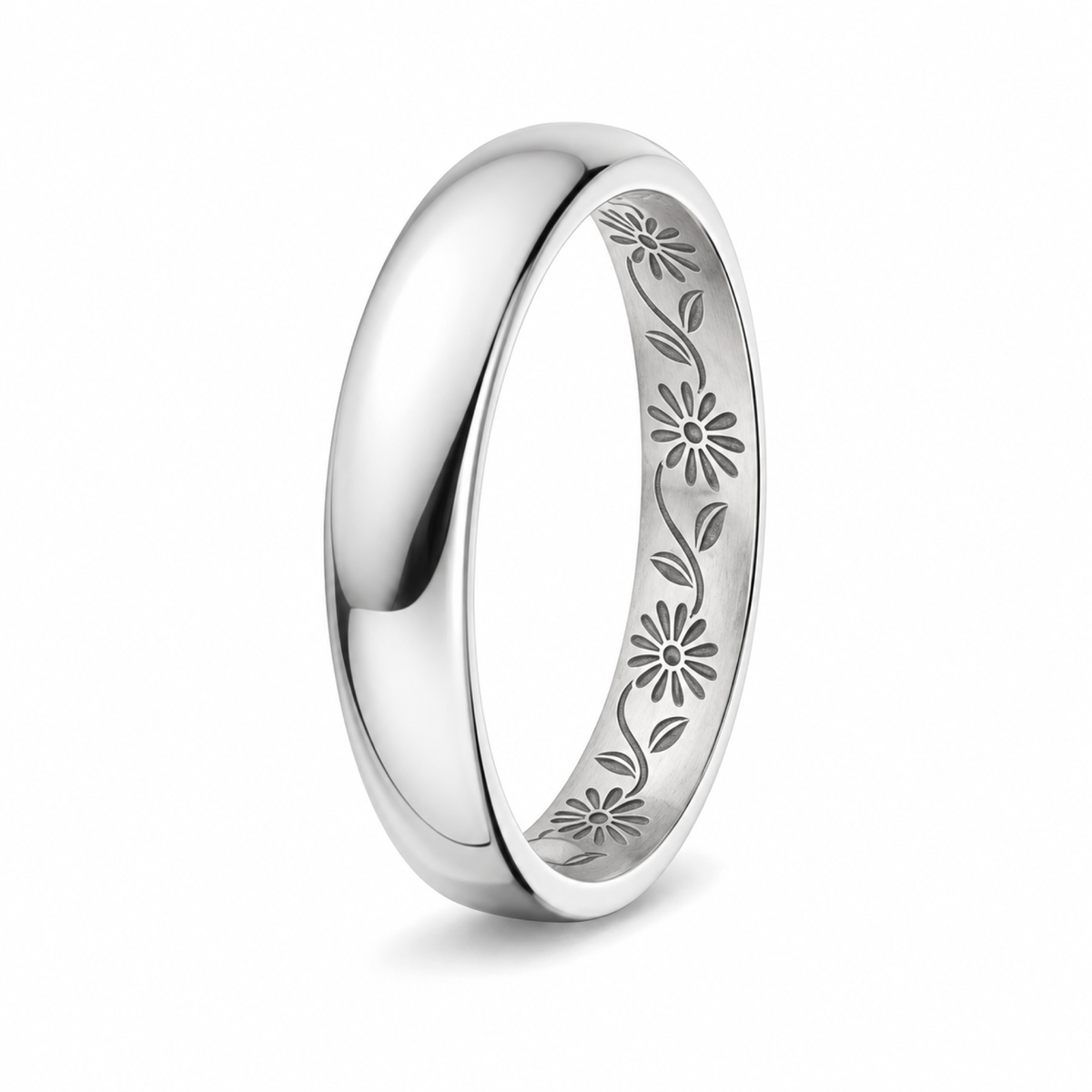 A polished platinum wedding ring with an engraved floral vine pattern inside the band.