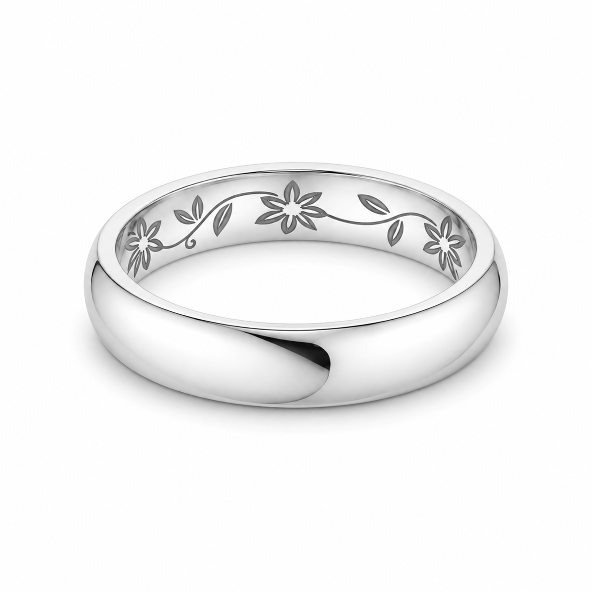 A polished platinum wedding ring featuring an engraved floral vine pattern along the inner band.