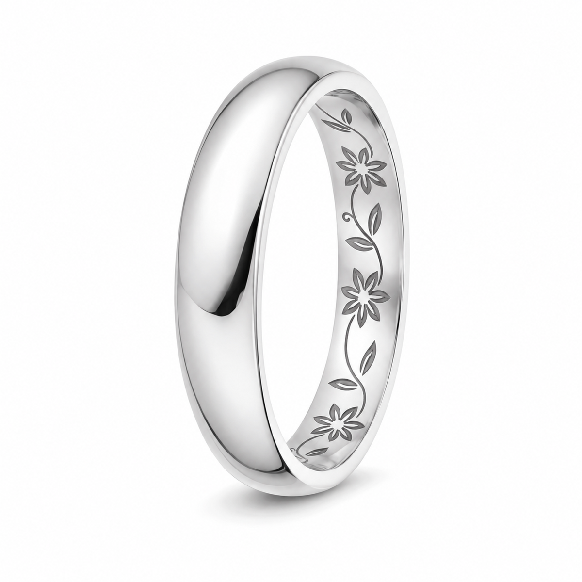 A polished platinum wedding ring with an engraved floral vine pattern inside the band.