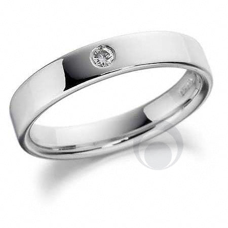 A polished platinum wedding band with a visible diamond on the inside face.