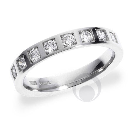 A diamond platinum wedding ring with a polished finish and a round brilliant cut diamond in the center.