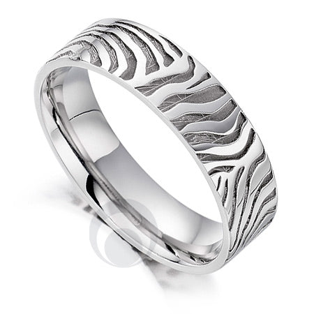 A platinum patterned wedding ring with a zebra design pattern.