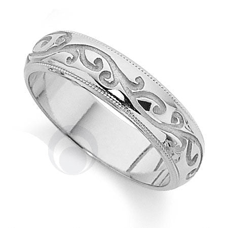 A polished platinum wedding ring with a classic cut pattern.