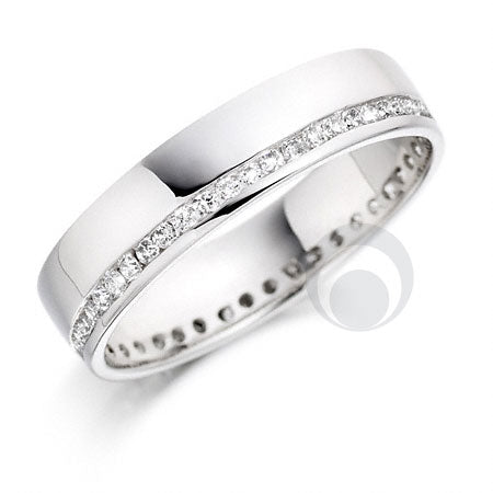 A polished platinum diamond wedding ring with a single row of round brilliant diamonds set all around the band.