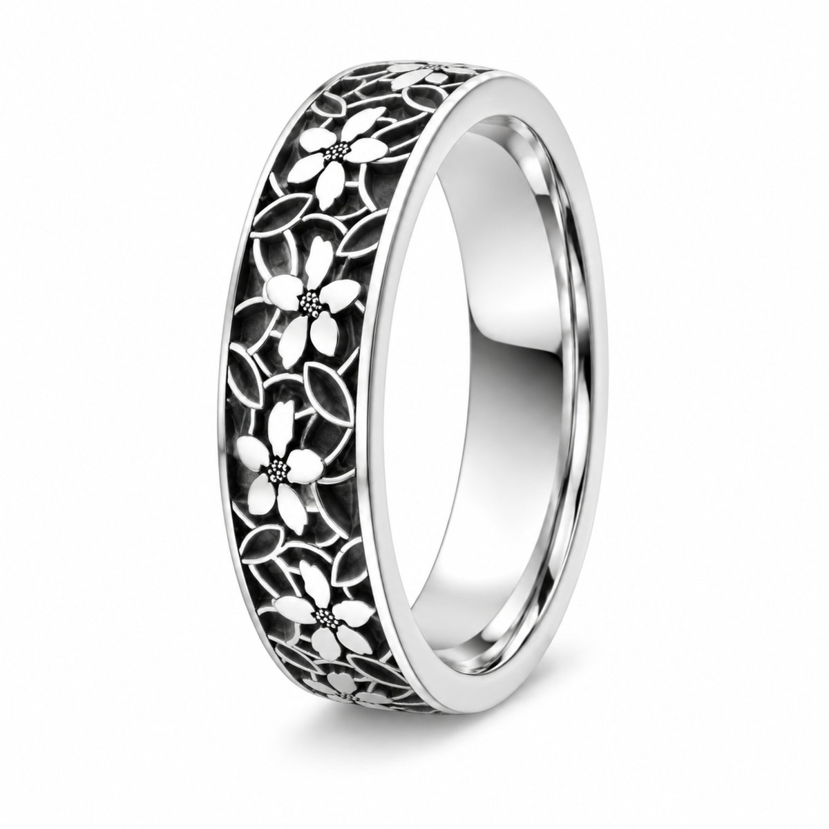 A platinum wedding ring featuring an intricate black and silver floral filigree pattern.