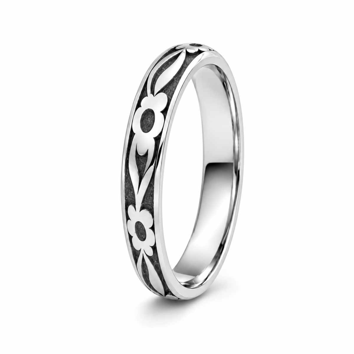 A platinum wedding ring featuring a black recessed inlay with a white floral pattern.