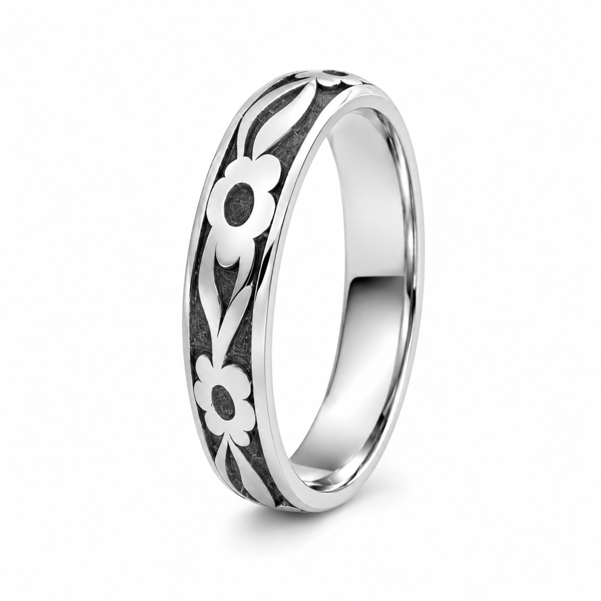 A platinum wedding ring featuring a white floral inlay pattern with black recessed detailing.