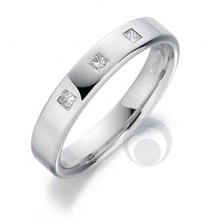 A  diamond platinum wedding ring with a polished finish, featuring a princess-cut diamond centerpiece.