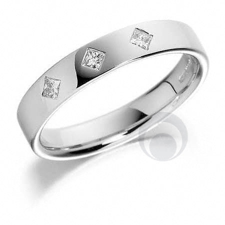 A diamond platinum wedding ring with a polished finish and a small diamond embellishment on the top.