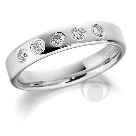 A  diamond platinum wedding ring with a round brilliant cut diamond in the center surrounded by smaller clear diamonds set in a polished or matte finish.