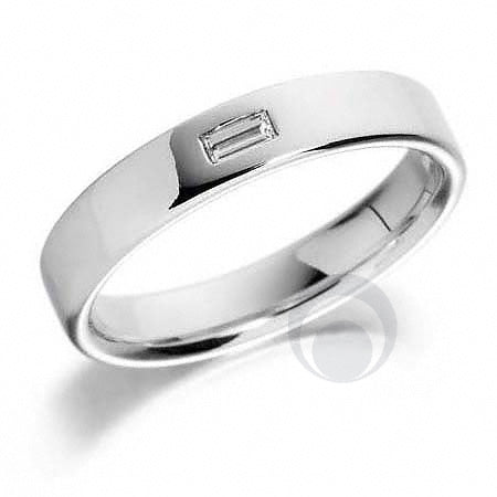 A platinum wedding ring set with one baguette diamond. The ring has a polished finish.