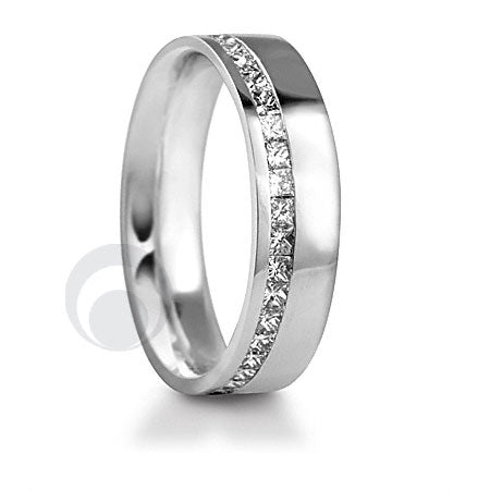 A diamond platinum wedding ring with a polished finish, featuring a channel-set diamond on the top part.