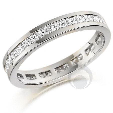 A polished platinum eternity ring with a channel-set design and a princess-cut diamond centerpiece.