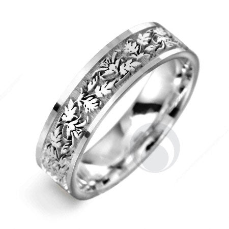 A polished platinum wedding ring with a celtic geometric pattern design.
