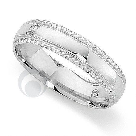 A polished platinum wedding ring with a classic cut pattern.