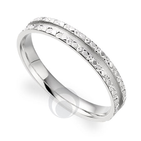 A  platinum wedding ring with a classic cut pattern and a polished finish.