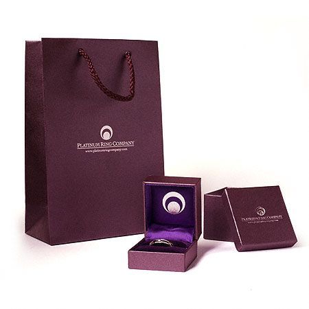 A purple platinum ring company gift bag and box.